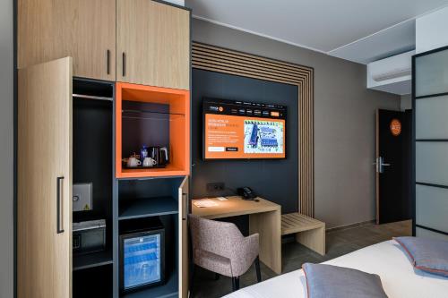 ein Zimmer mit einem Bett und einem Schreibtisch mit Computer in der Unterkunft Orange Hotel La Louvière in La Louvière