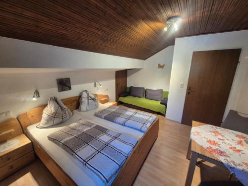 a large bedroom with two beds and a couch at Klein Schöntal in Göstling an der Ybbs