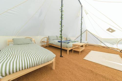 a room with two beds in a tent at Boscoppa Farm-Emperor Tent No2 in Trethurgy