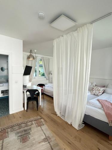 a bedroom with two beds and a desk with a computer at Domizil Gols, Studios Am Anger in Gols
