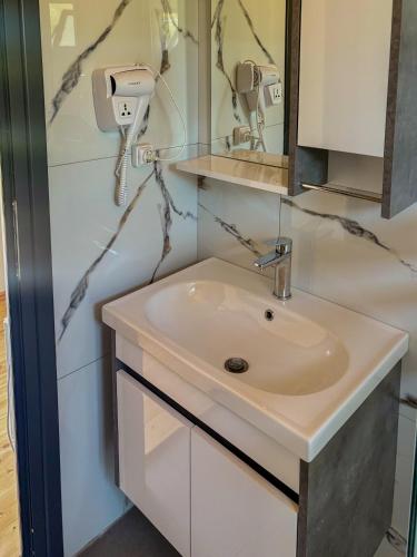 a bathroom with a sink and a mirror at Sandri Nature Lodge in Karahaxh