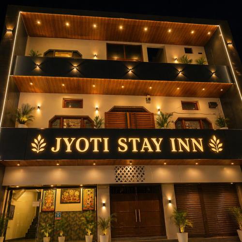 a jyoti stay inn is lit up at night at Hotel Jyoti Stay Inn 2 Min to Ram Tample in Ayodhya