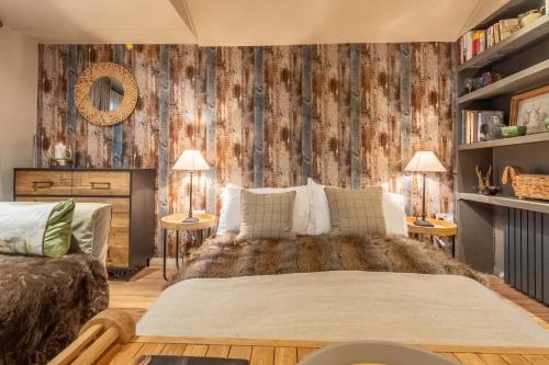 a bedroom with a large bed in a room at The Bothy in Ringstead