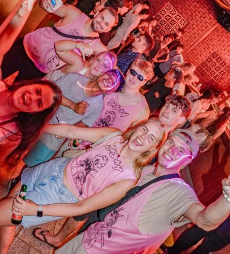 a group of people in a crowd at a party at Lushy Hostel Kuta Legian in Legian