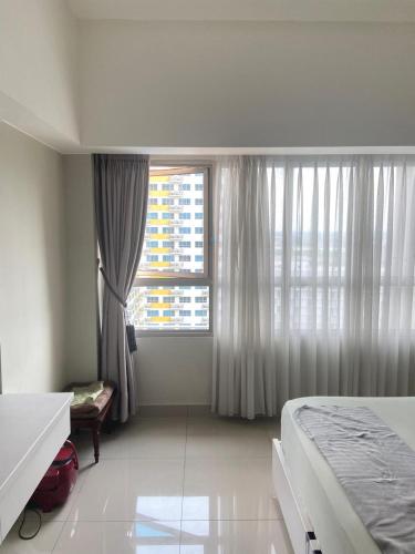 a white room with a bed and a window at Springlake apartment b in Rawabugel
