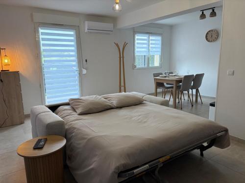 a bedroom with a bed and a dining room with a table at L'essentiel in Hambach