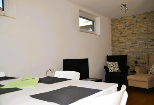 a room with a white table and chairs and a brick wall at Casa Bicicletta in Fuschl am See