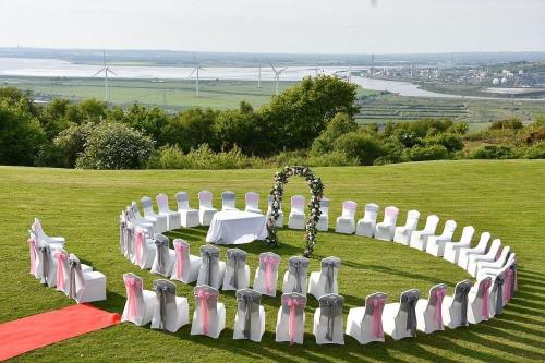 a group of chairs in a circle on a field at Forest Hills Hotel & Country Club in Frodsham
