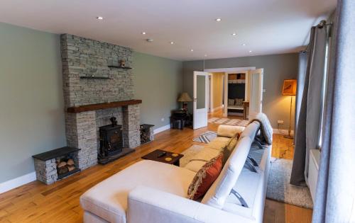 a living room with a couch and a fireplace at Kerry Hideaway - Killorglin in Killorglin