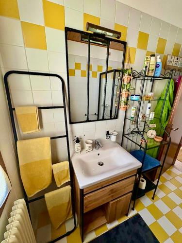 a bathroom with a sink and a mirror at Casetta La Pera in Perarolo