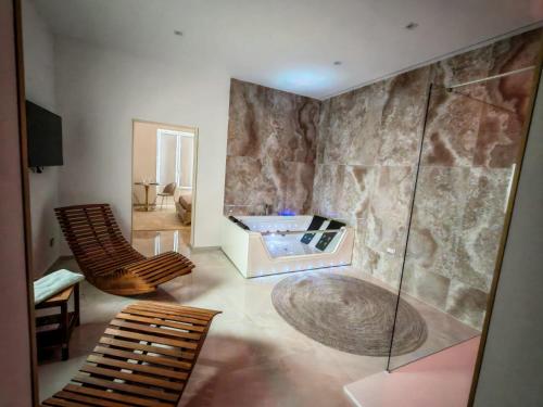 a bathroom with a shower and a tub at Suite Crystal Home with Jacuzzi in Trapani
