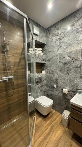a bathroom with a shower and a toilet and a sink at Копа Баварія - Львів Готель in Pasiky-Zubryts'ki