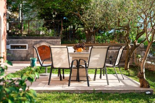 a table and chairs sitting on a patio at Radonjić Apartments in Kotor