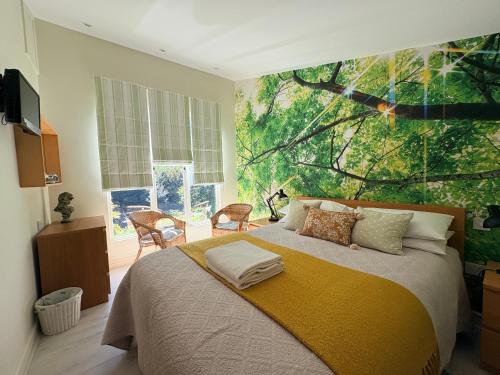 a bedroom with a bed with a painting on the wall at The Steppes Holiday Cottages in Hereford