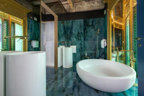 a bathroom with a large white tub in a room at Tenuta Il Poggio - Luxury B&B in Felegara