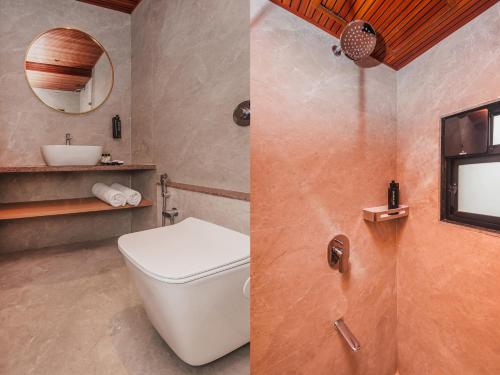 two pictures of a bathroom with a toilet and a sink at RaRa Residence in Mumbai