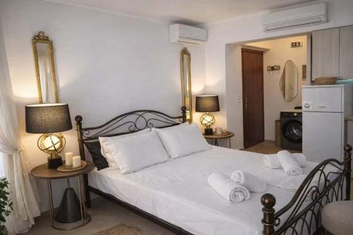 a bedroom with a bed with white sheets and pillows at Sun Suite in Sitia