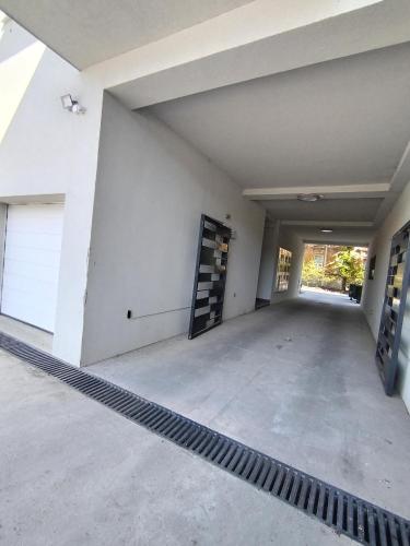 an empty garage with a garage door and a driveway at Allegra lux in Sombor