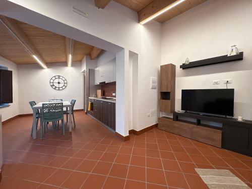 a kitchen and dining room with a table and a television at Sant'Elia B&B in Alessandria del Carretto