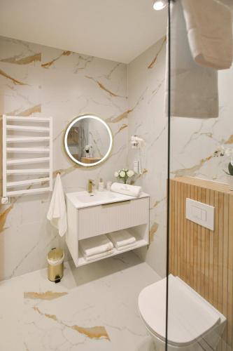 a bathroom with a sink and a mirror at White House Residence Zator-blisko Energylandii in Zator
