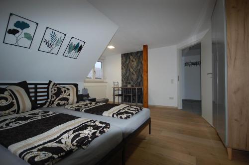 a bedroom with two beds and a hallway at Haus Schambachtal in Treuchtlingen