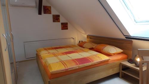 a bedroom with a bed in a attic at Ferienwohnung Mohnblume in Gerswalde