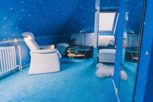 a room with a blue room with bunk beds at Dům cestovatele in Uherský Brod
