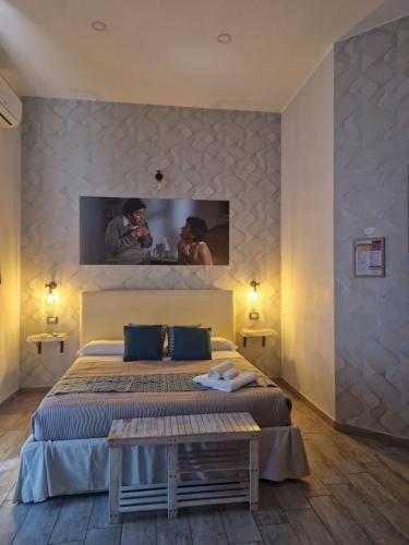 a bedroom with a bed and a tv on the wall at Artisti Sustinea Rooms in Naples