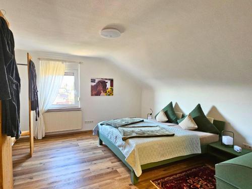 a bedroom with a bed and a window at Ferienwohnung Schwarzhof- Hahnekräh am Bostalsee, helle 75 qm & hundefreundlich in Nohfelden