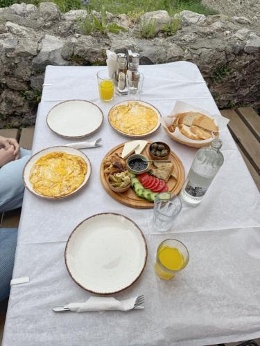 a white table with plates of food on it at Vila Kalaja Kruje, Inside The Castle in Krujë
