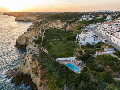 an aerial view of a village on a cliff near the ocean at Refugio in Carvoeiro