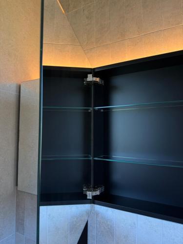 a shower with glass shelves in a bathroom at Chosen Hideaway Near Cologne in Neunkirchen-Seelscheid