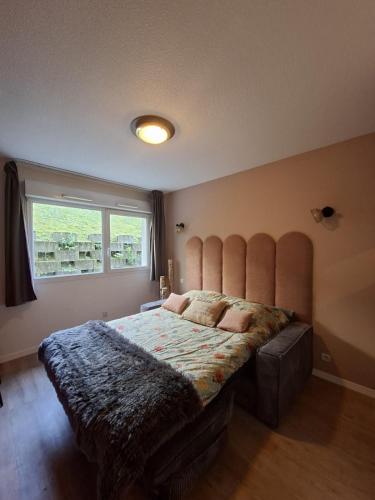 a bedroom with a large bed with a large window at Le 540 - Annecy - Parking in Annecy