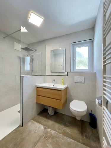 a bathroom with a sink and a toilet at Pension Waldheim in Mauterndorf