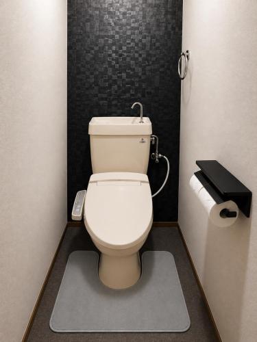 a bathroom with a white toilet in a stall at 徳島駅徒歩10分 公園前 Netflix DiDi Base 203 in Tokushima