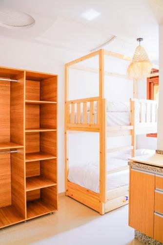 a bedroom with a bunk bed and shelves at Salty Life Surf House in Imsouane