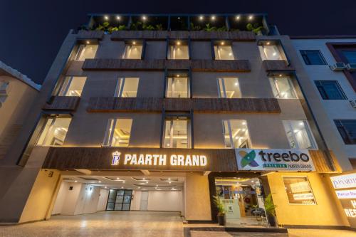 a front view of a building with a parking garage at Treebo Premium Paarth Grand with Pure Veg Restaurant in Haridwār