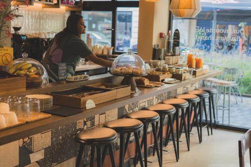 a man standing at a counter in a restaurant with a counter sidx sidx at The Usual Brussels in Brussels