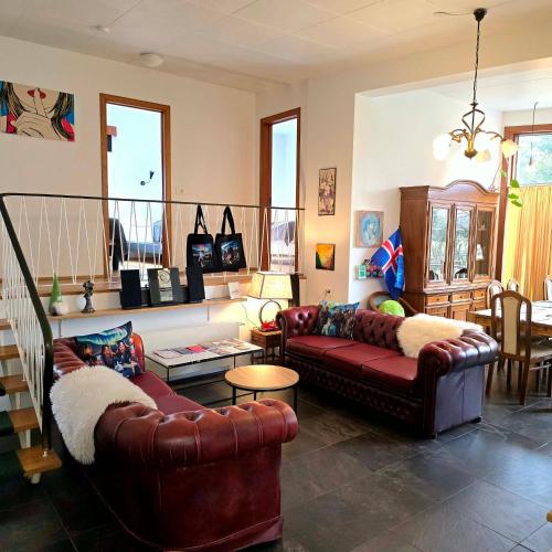 a living room with two couches and a table at Spói Guesthouse in Hvolsvöllur