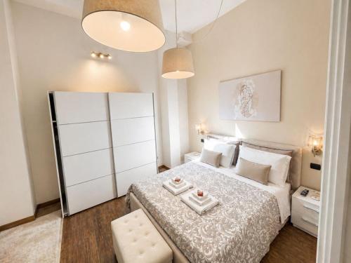 a small bedroom with a bed and a white cabinet at Albachiara Apartment in Lampedusa