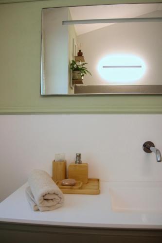 a mirror above a bathroom sink with a towel at Casa MaeVi in Galzignano