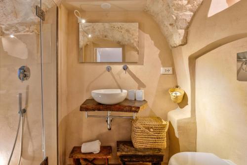 a bathroom with a sink and a shower at Ostuni Luxury Stay - 2 Jacuzzi in Ostuni