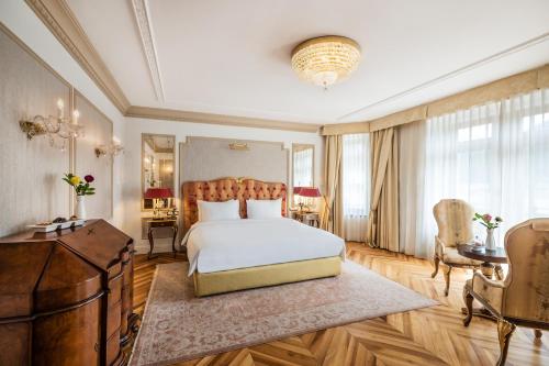 a bedroom with a bed and a dresser and a desk at Hotel Flüela Davos - The Unbound Collection by Hyatt in Davos