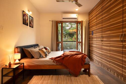 a bedroom with a bed and a window at LiveAway Bengaluru, HSR by PACK in Bangalore
