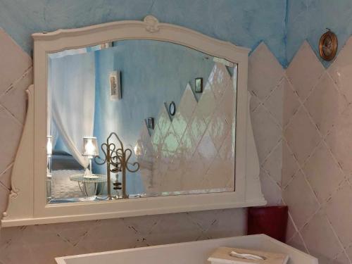 a bathroom with a mirror above a sink at Le Clos des 4 Saisons in La Rochepot