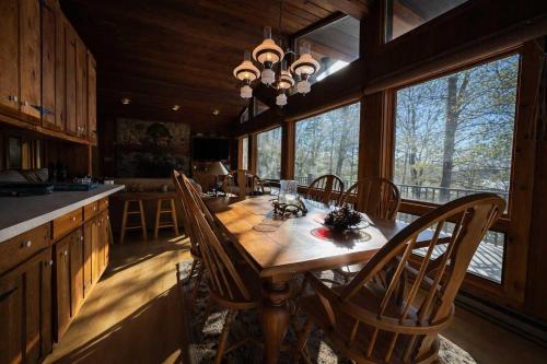 a dining room with a wooden table and chairs at Stack's Back Bay Retreat in Minocqua