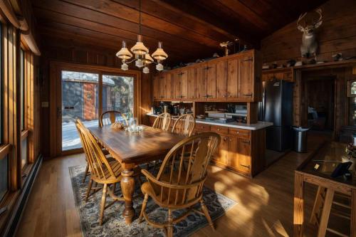 a dining room with a wooden table and chairs at Stack's Back Bay Retreat in Minocqua