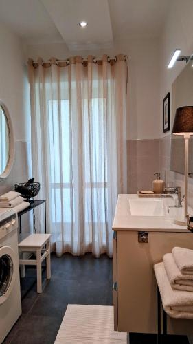 a bathroom with a sink and a washing machine at Casa Bruna in Levanto