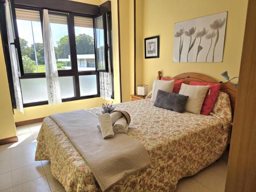 a bedroom with a large bed and a window at Apartamento Candela 6904 in Noja
