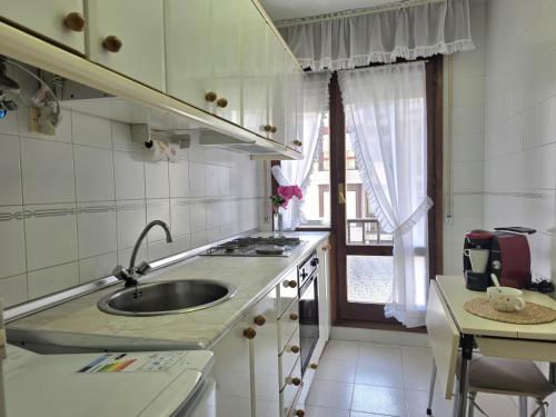 a small kitchen with a sink and a window at Apartamento Candela 6904 in Noja